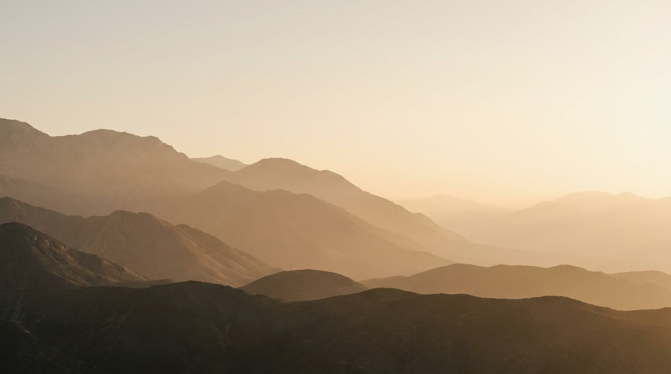Warm mountain landscape at golden hour representing growth and clarity